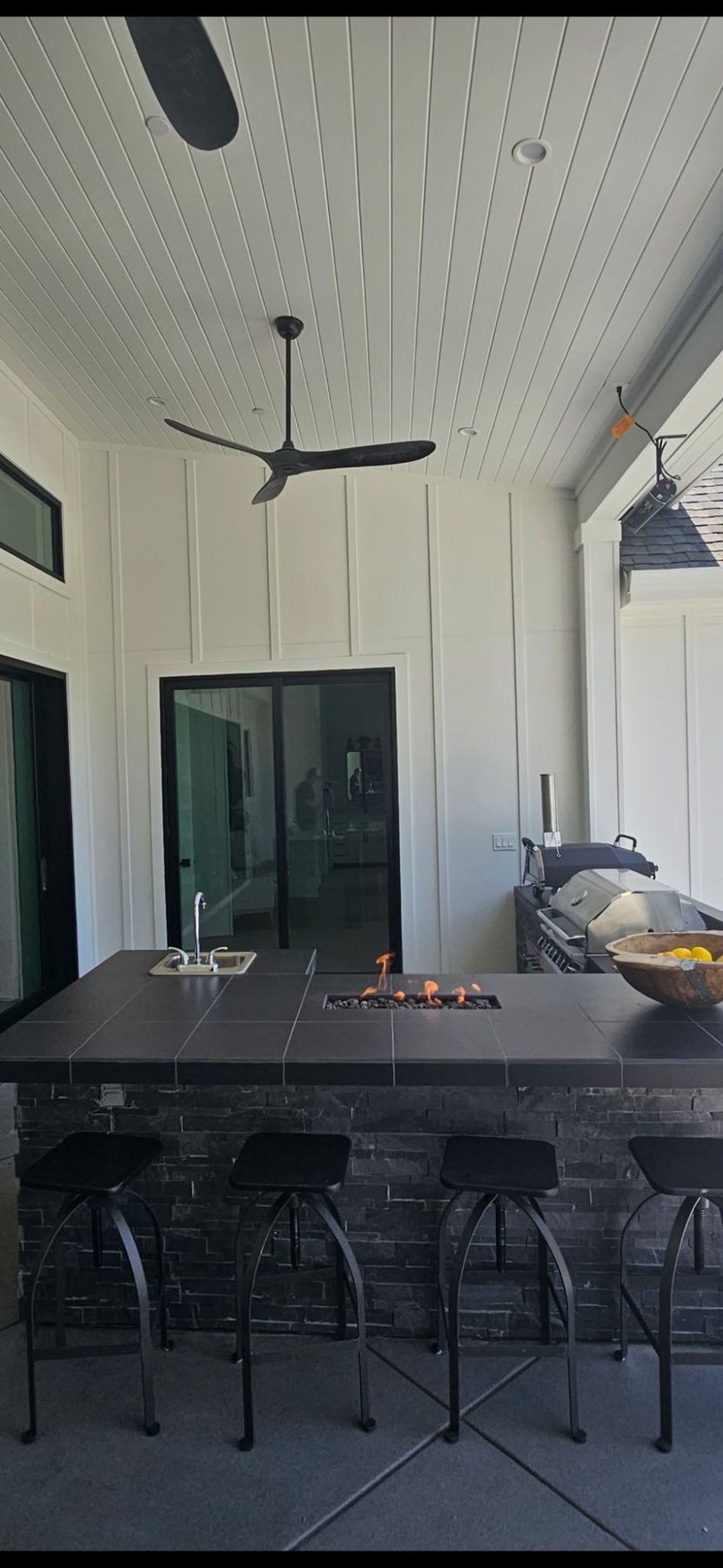 Custom stone seating bar with a built-in fire feature