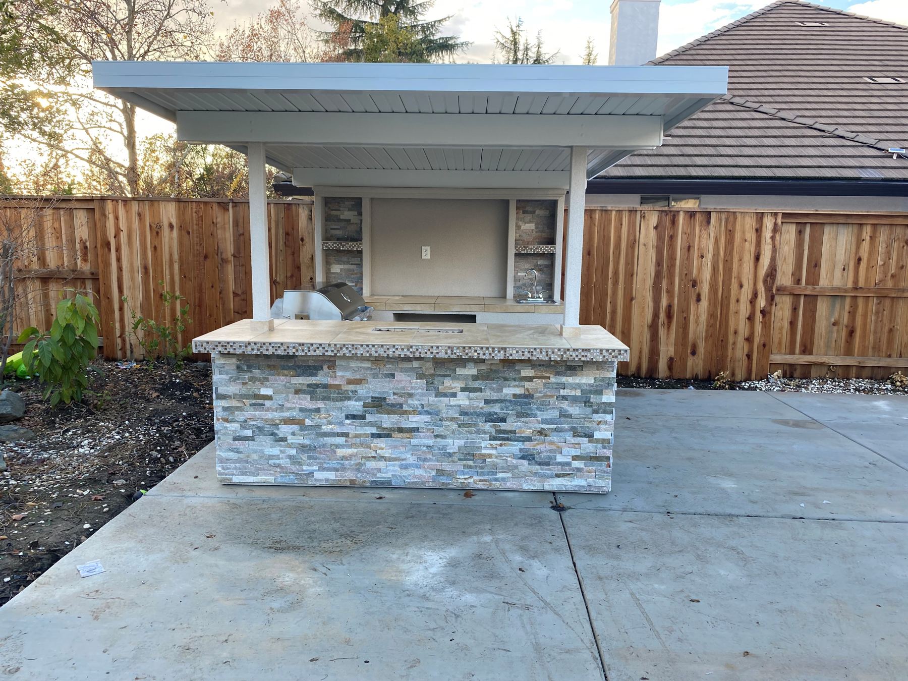 Custom covered outdoor kitchen built by Just BBQ Grills