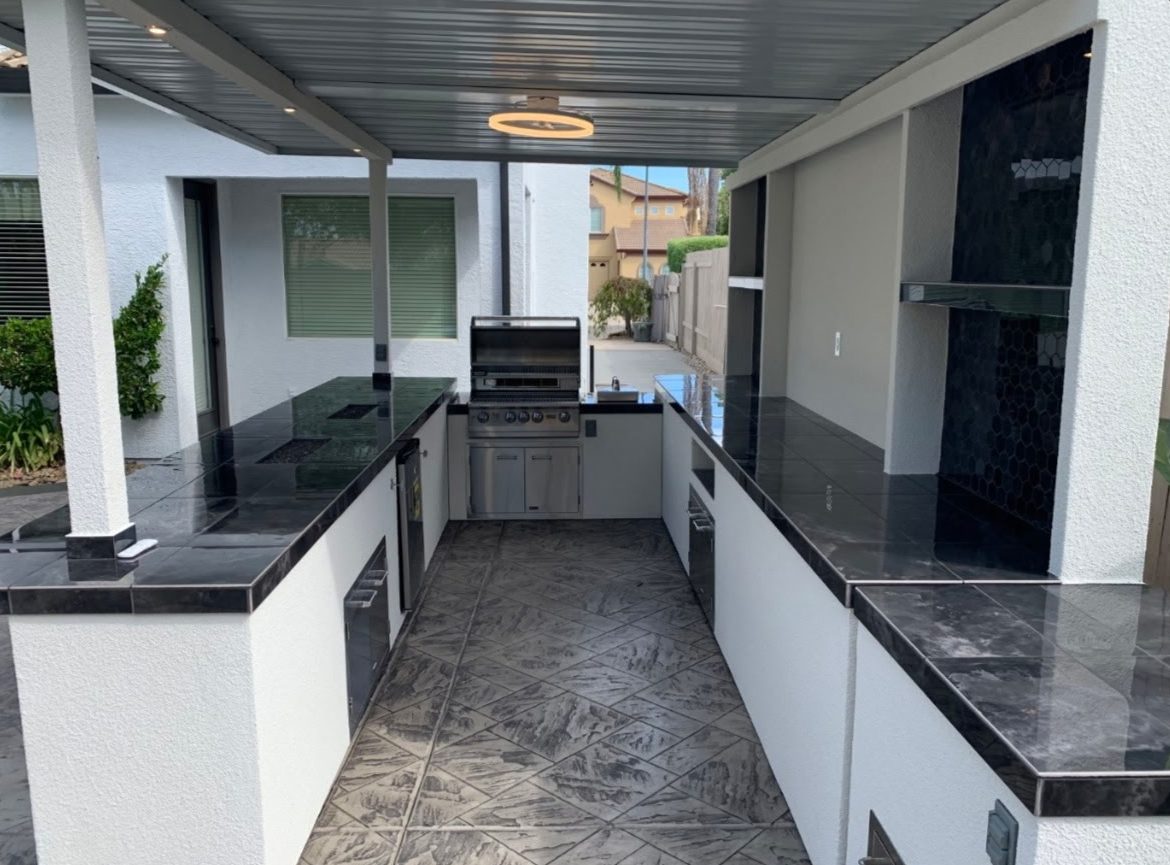Galley layout entertainment cabana with stainless grill and bar seating