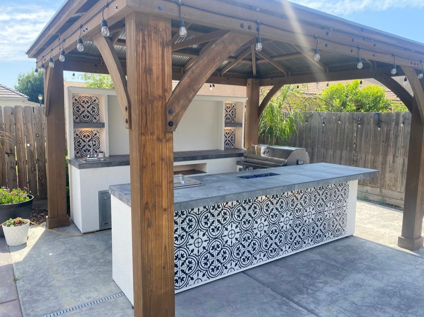Covered outdoor kitchen gazebo with Spanish tile accents