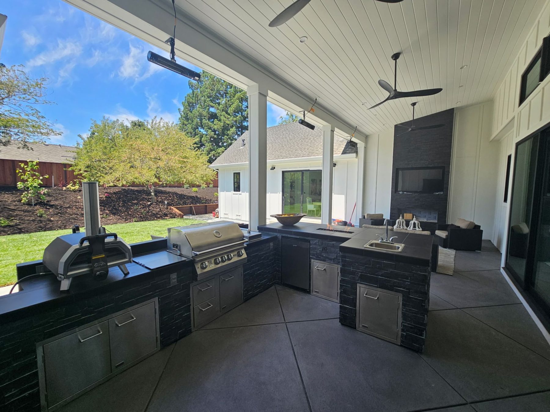 Custom stacked-stone outdoor kitchen with Lion stainless grill