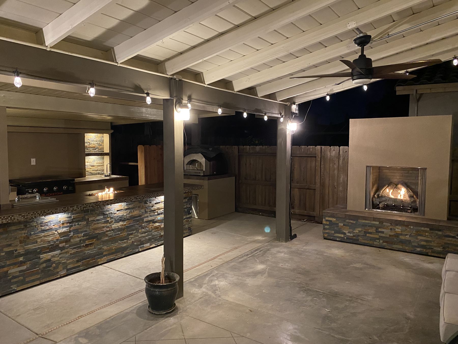 Custom covered outdoor kitchen at night built by Just BBQ Grills